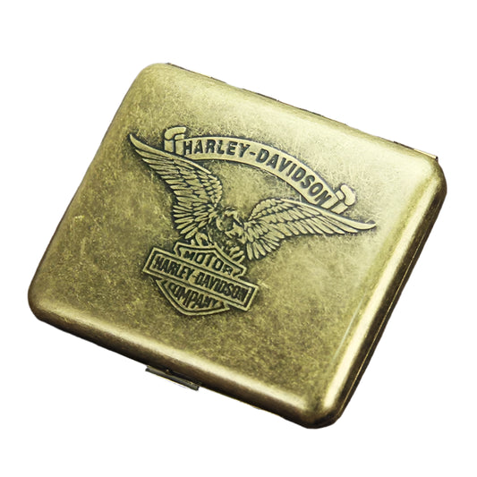 Gold Harley-Davidson cigarette case on a wooden surface